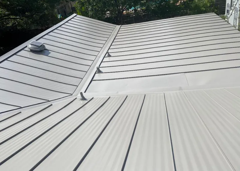 Solar attic fan installed on a metal roof for Roof Ventilation in Hickam Housing